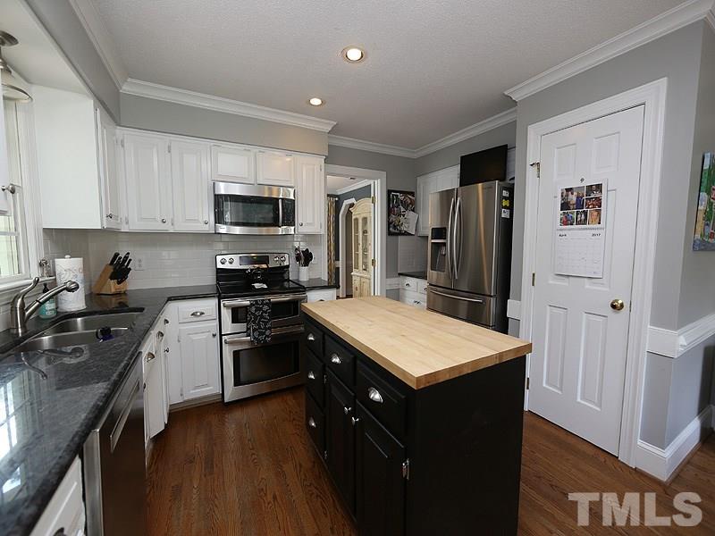 2501 Bredon Court Raleigh, NC 27613 - Photo 7 of 25 a kitchen with a refrigerator stove top oven and sink