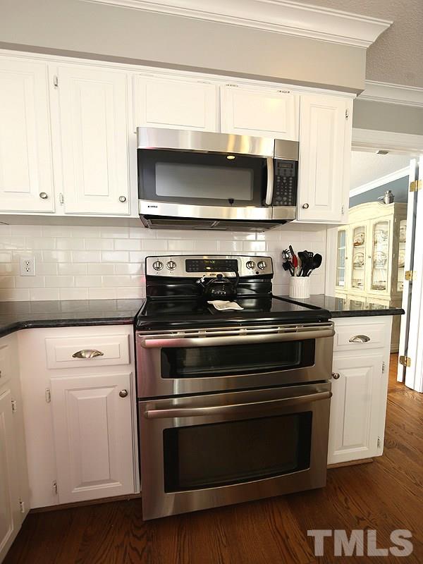 2501 Bredon Court Raleigh, NC 27613 - Photo 8 of 25 a stove top oven sitting inside of a kitchen