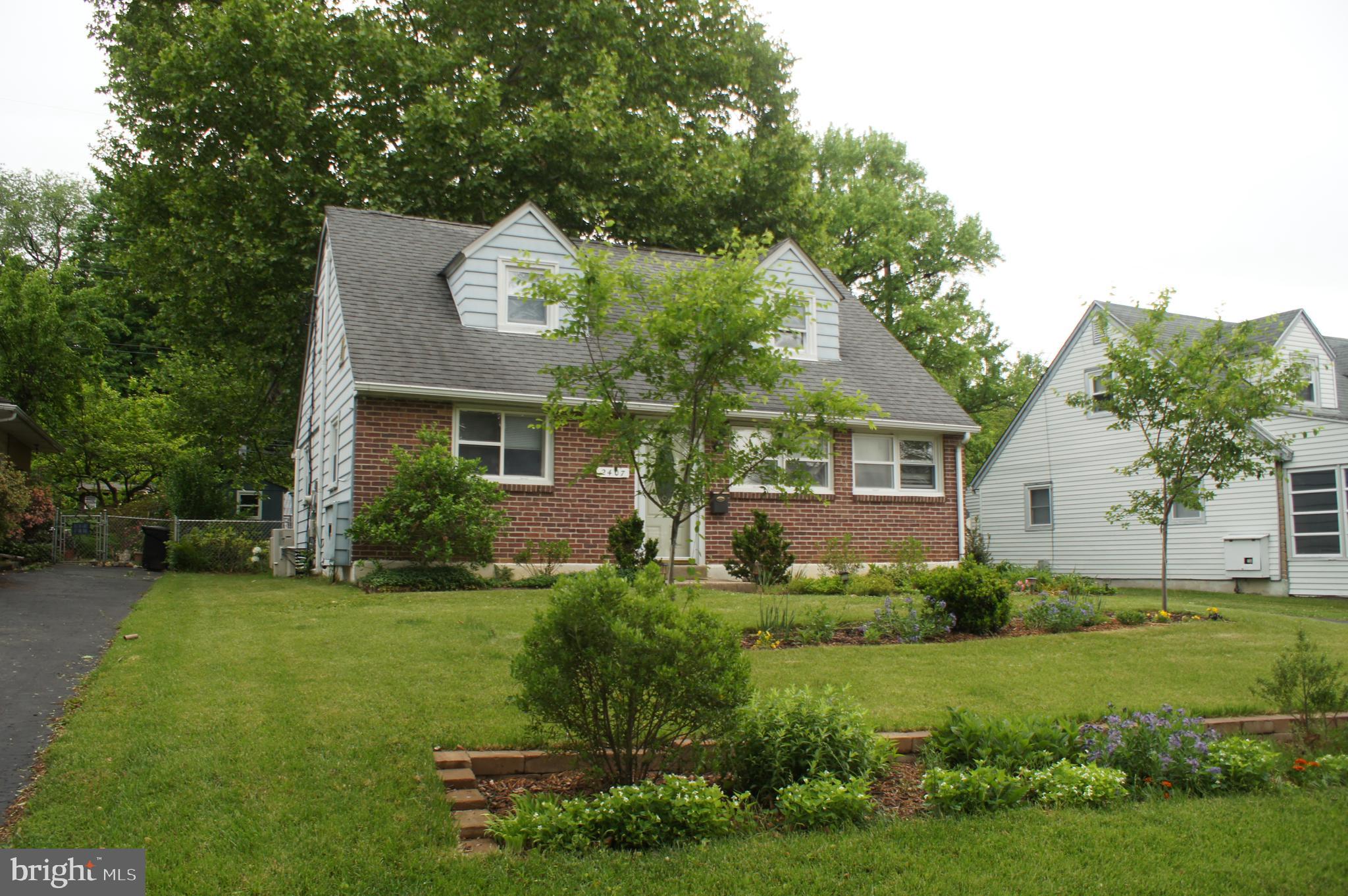 2407 Secane Road Secane, PA 19018 - Photo 3 of 3 a front view of a house with a yard and trees