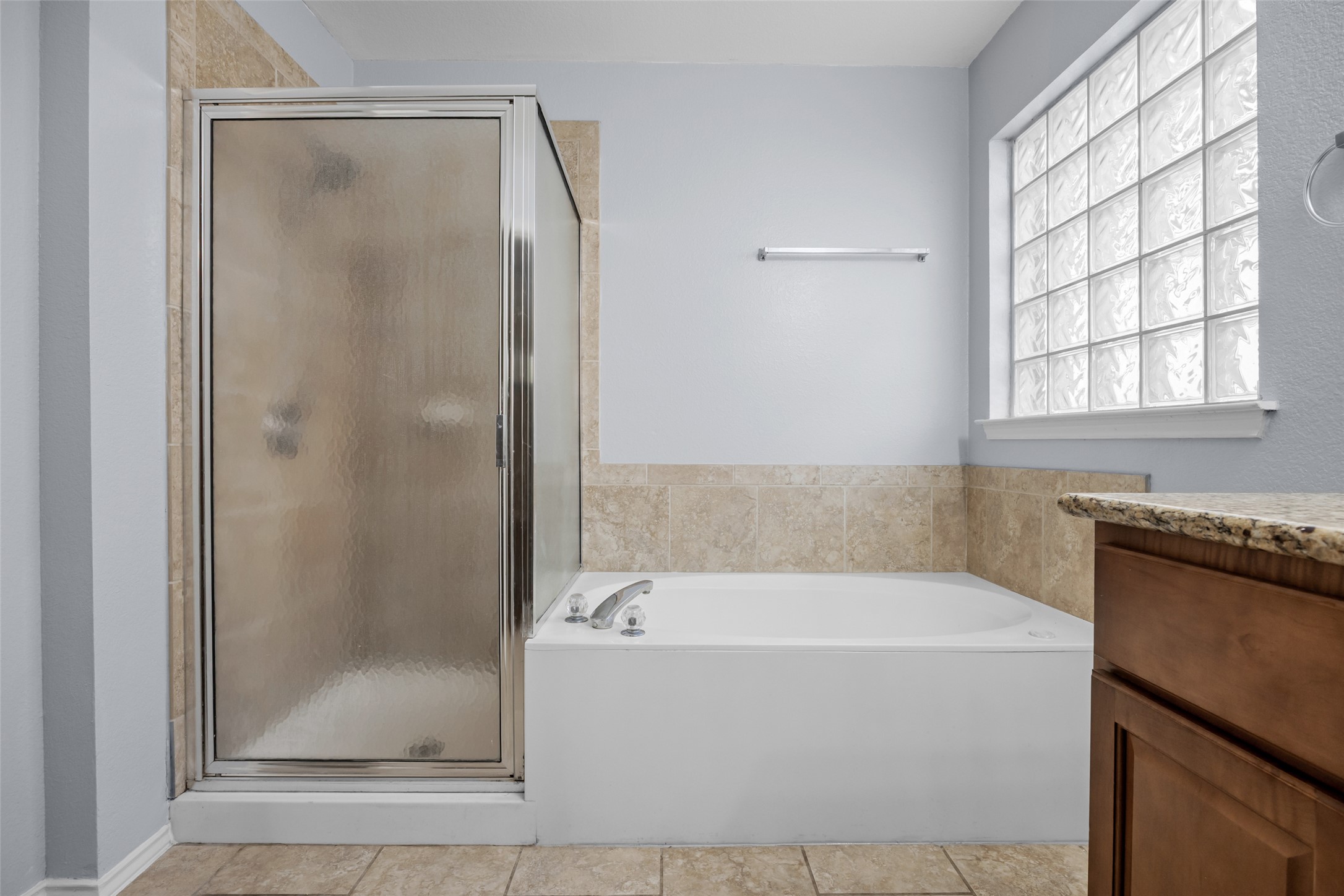 15918 Two Rivers Cove Austin, TX 78717 - Photo 20 of 30 Renovated primary bathroom with granite and modern fixtures.
