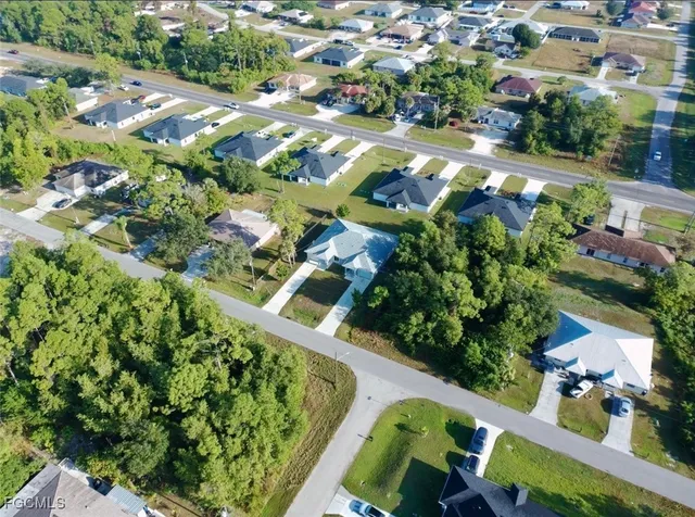 an aerial view of residential houses with outdoor space