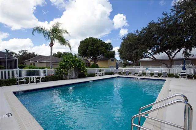 a view of a swimming pool with a patio and a garden