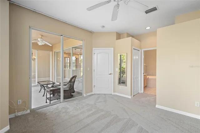 a view of a hallway with furniture and chandelier fan