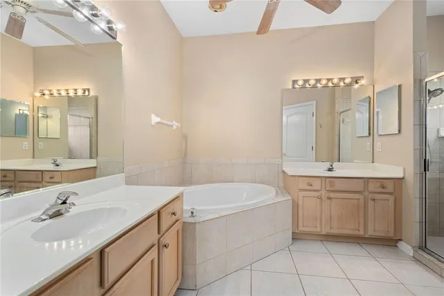 a bathroom with a granite countertop sink a toilet a mirror and bathtub