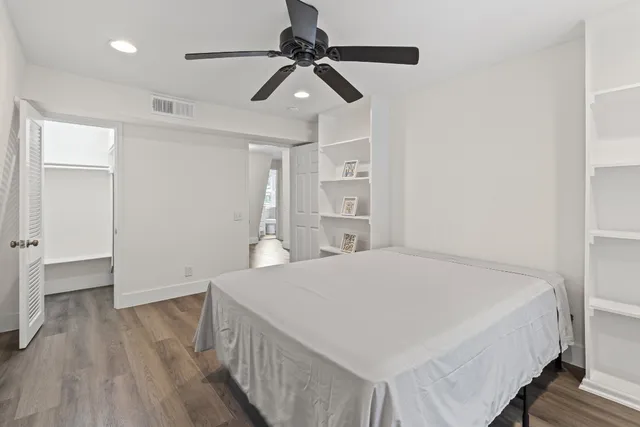 a bedroom with a bed and a ceiling fan