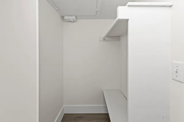 a view of walk in closet with empty racks