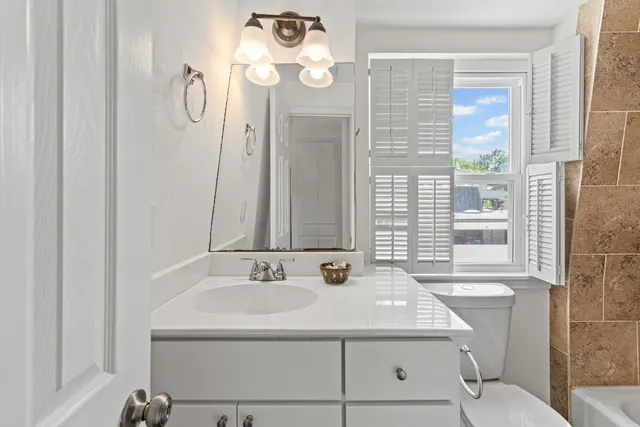 a bathroom with a sink a mirror and a shower