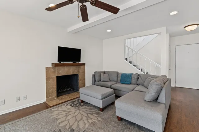 a living room with furniture a flat screen tv and a fireplace