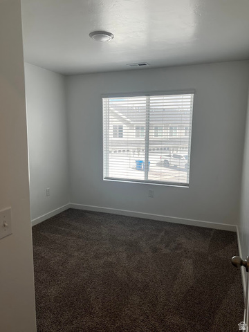 562 Hal Street, Unit 152 Tooele, UT 84074 - Photo 16 of 44 Carpeted room featuring a window with blinds, white walls, and a flush-mount ceiling light