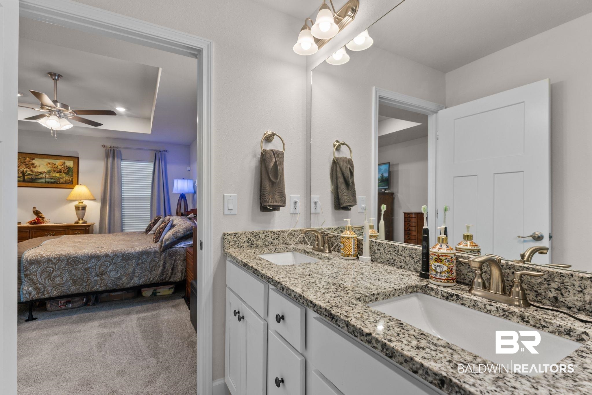 692 Mayflower Drive Foley, AL 36535 - Photo 28 of 40 Bathroom featuring ensuite bath, double vanity, a tray ceiling, ceiling fan, and light carpet