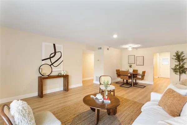 a living room with furniture and wooden floor