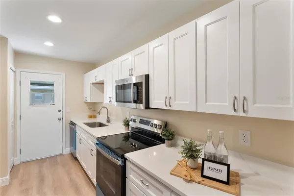 a kitchen with a sink a stove and refrigerator