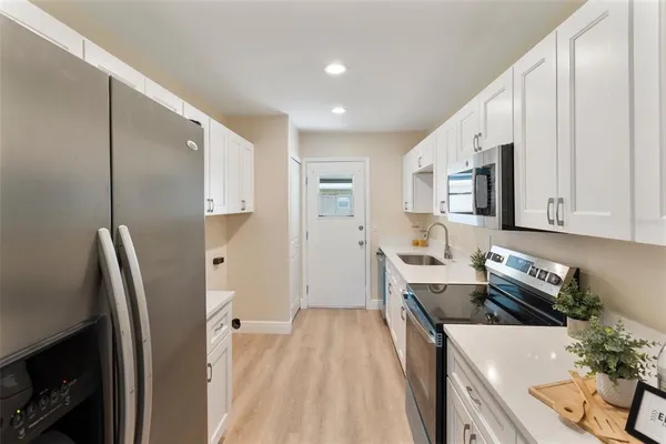 a bedroom with a bed and a lamp