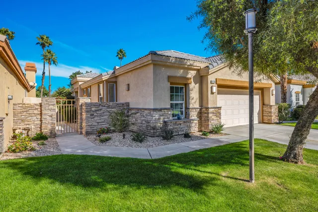 a living room with furniture ceiling fan and a potted plant