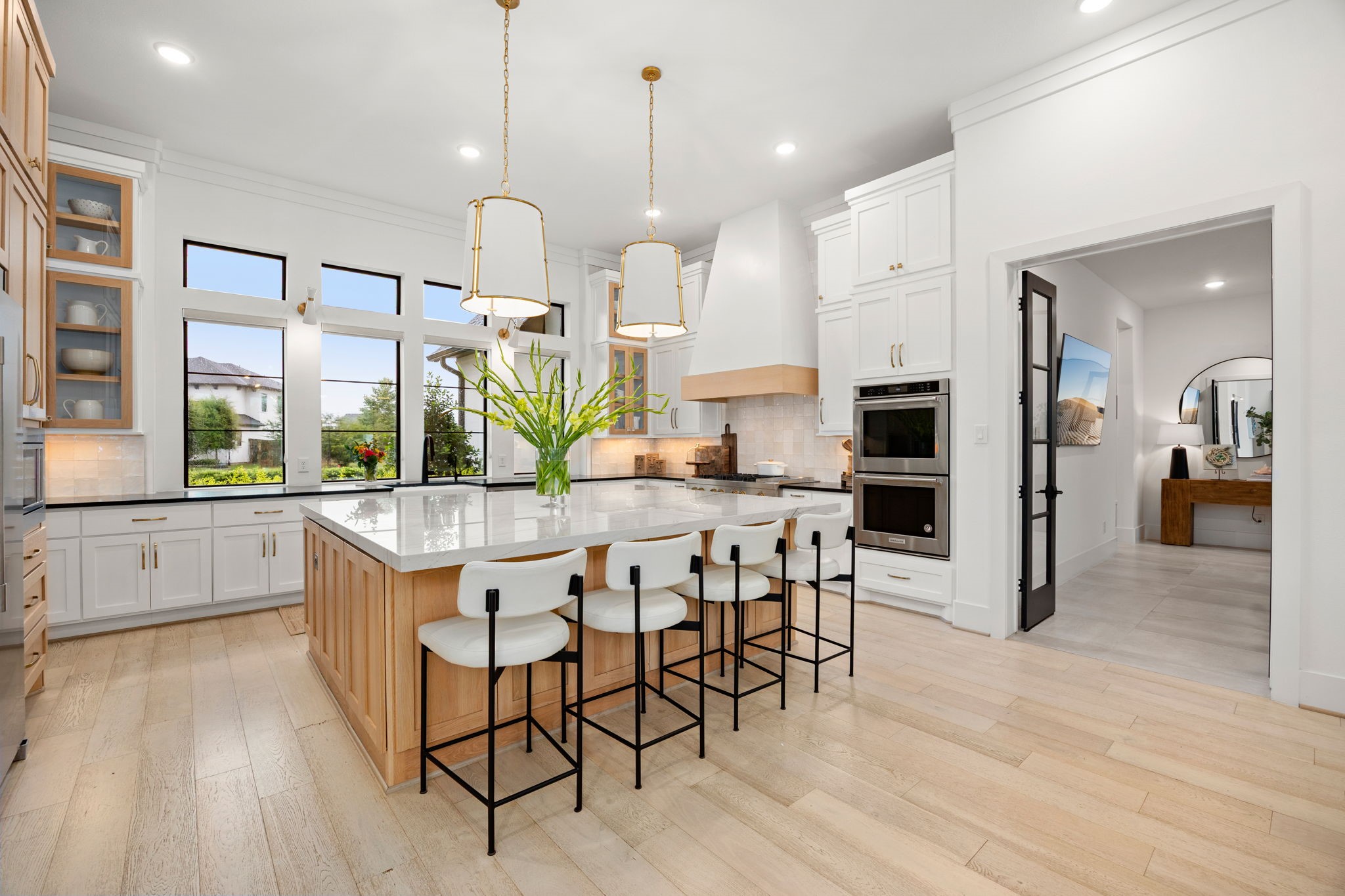 27903 Indigo Ridge Drive Fulshear, TX 77441 - Photo 11 of 50 Expansive chef’s kitchen showcasing a large center island, double ovens, and generous seating for gathering and entertaining.