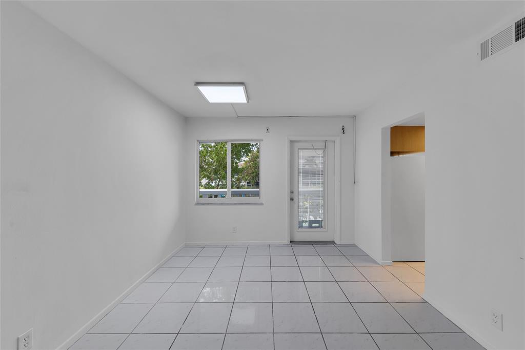 2151 Northeast 42nd Court, Unit 230 Lighthouse Point, FL 33064 - Photo 14 of 40 an empty room with windows