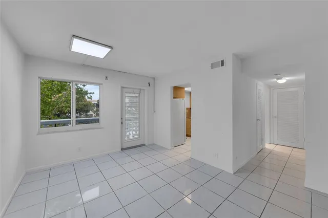 a view of an empty room with closet area