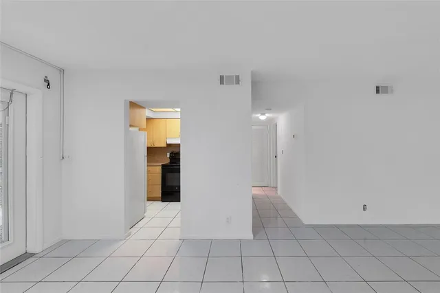 a view of an empty room with windows