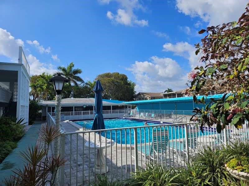 2151 Northeast 42nd Court, Unit 230 Lighthouse Point, FL 33064 - Photo 2 of 40 a view of a balcony with plants and lake view
