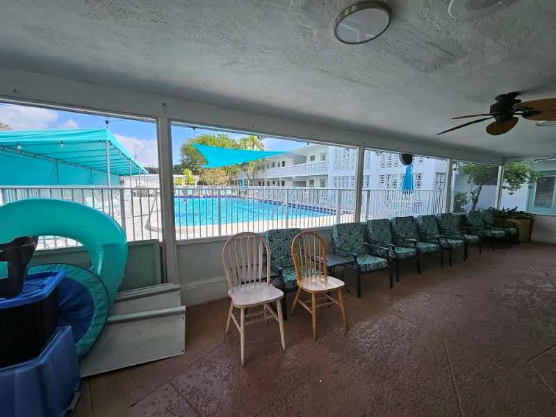 2151 Northeast 42nd Court, Unit 230 Lighthouse Point, FL 33064 - Photo 40 of 40 a living room with furniture and a floor to ceiling window