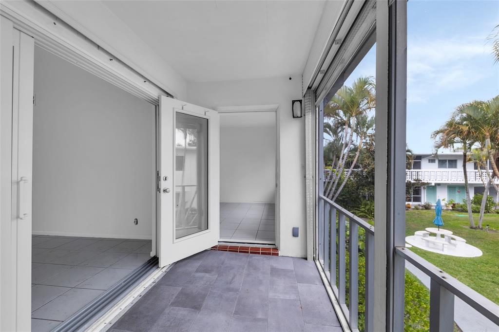 2151 Northeast 42nd Court, Unit 230 Lighthouse Point, FL 33064 - Photo 8 of 40 a view of an entryway with garden
