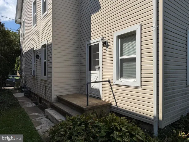 a view of a house with a yard and a garage