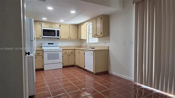a kitchen with stainless steel appliances a sink stove and microwave