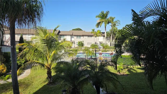 a view of a house with a tree in a yard