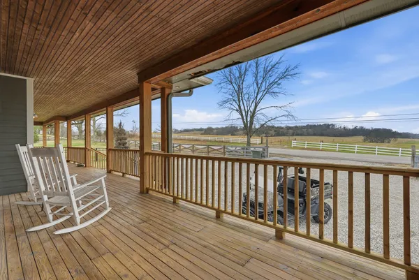 a dining room with furniture a chandelier and wooden floor