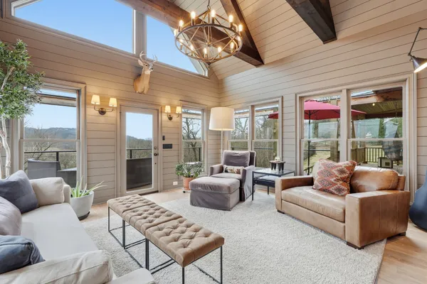 a bedroom with a large bed a flat tv screen and dresser