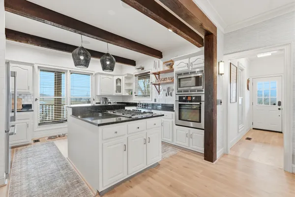 a bathroom with a sink a mirror a vanity and a bathtub