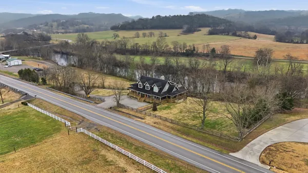 a view of a hallway with furniture and floor to ceiling window