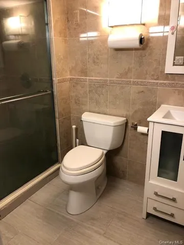 a white toilet sitting next to a bathroom sink