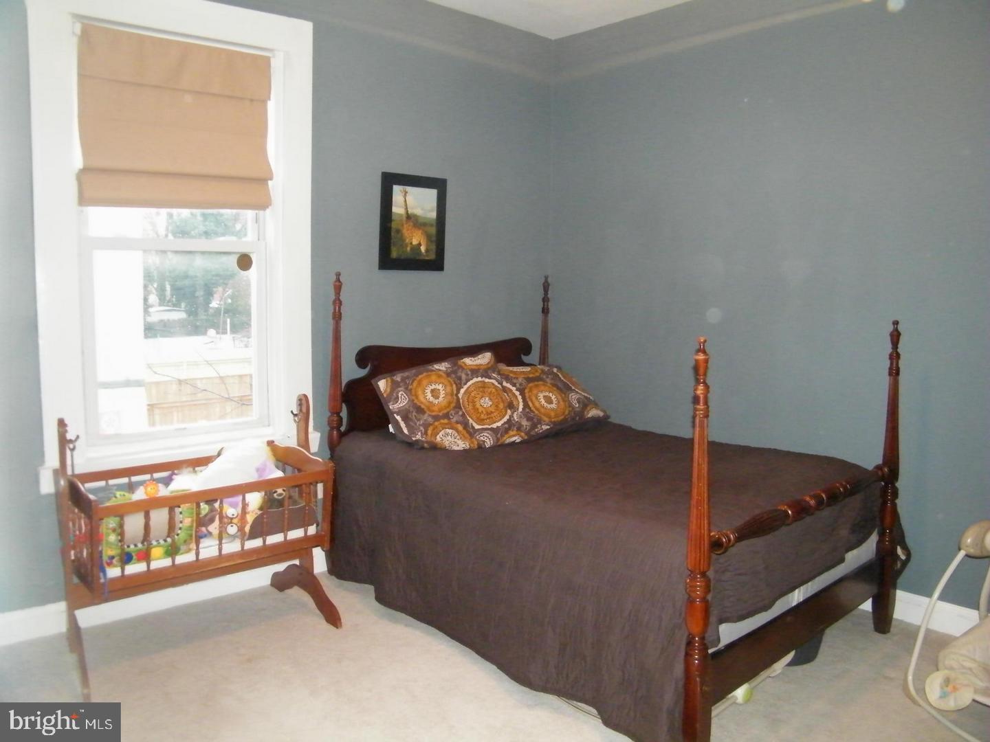 756 Morton Street Northwest Washington, DC 20010 - Photo 8 of 13 a bedroom with a bed and a window