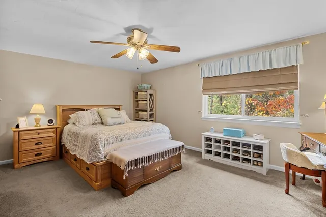 a spacious bedroom with a bed and a window