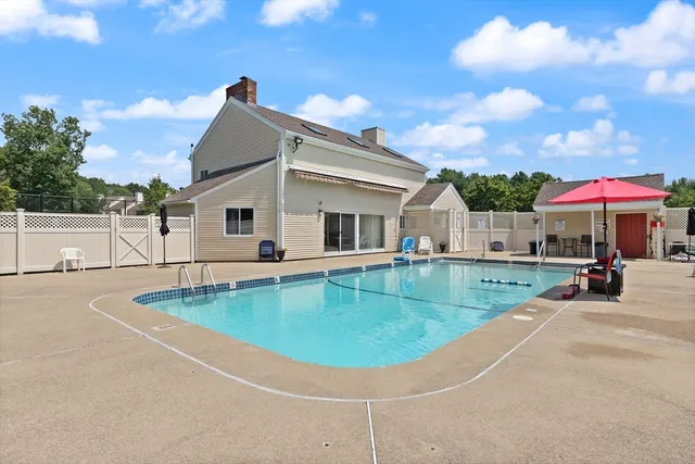 a view of a house with swimming pool and sitting area