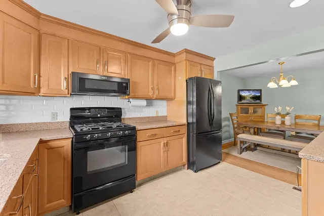 a kitchen with stainless steel appliances a stove a refrigerator and a sink