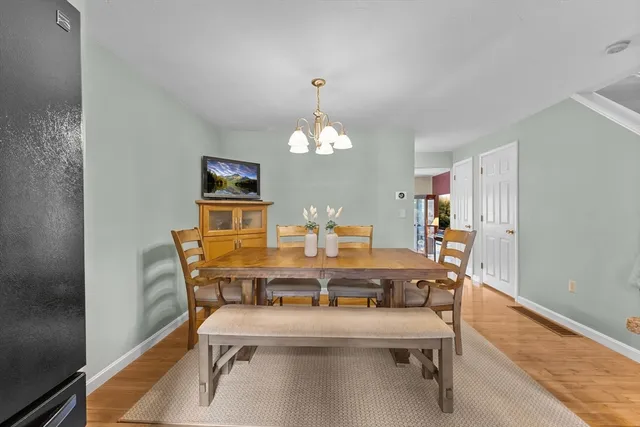 a view of a dining room with furniture and chandelier