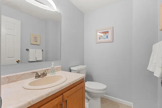 a bathroom with a sink a toilet and a mirror