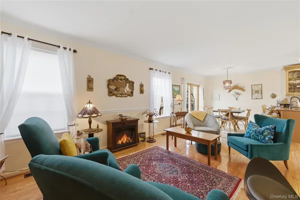 a living room with furniture wooden floor and a large window