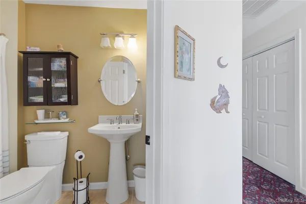 a bathroom with a sink mirror and toilet