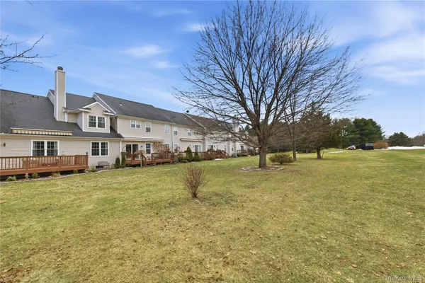 a view of a house with a yard and sitting area