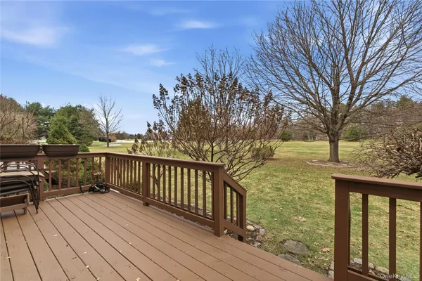 a view of balcony with wooden floor and fence