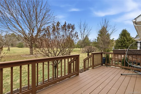 a balcony with wooden floor and fence