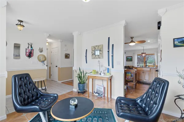 a living room with furniture a dining table and chairs