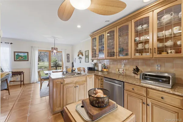 a kitchen with a stove a sink and cabinets
