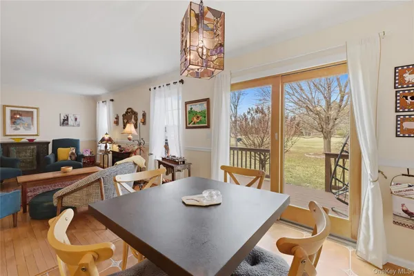 a view of a dining room with furniture large window and wooden floor