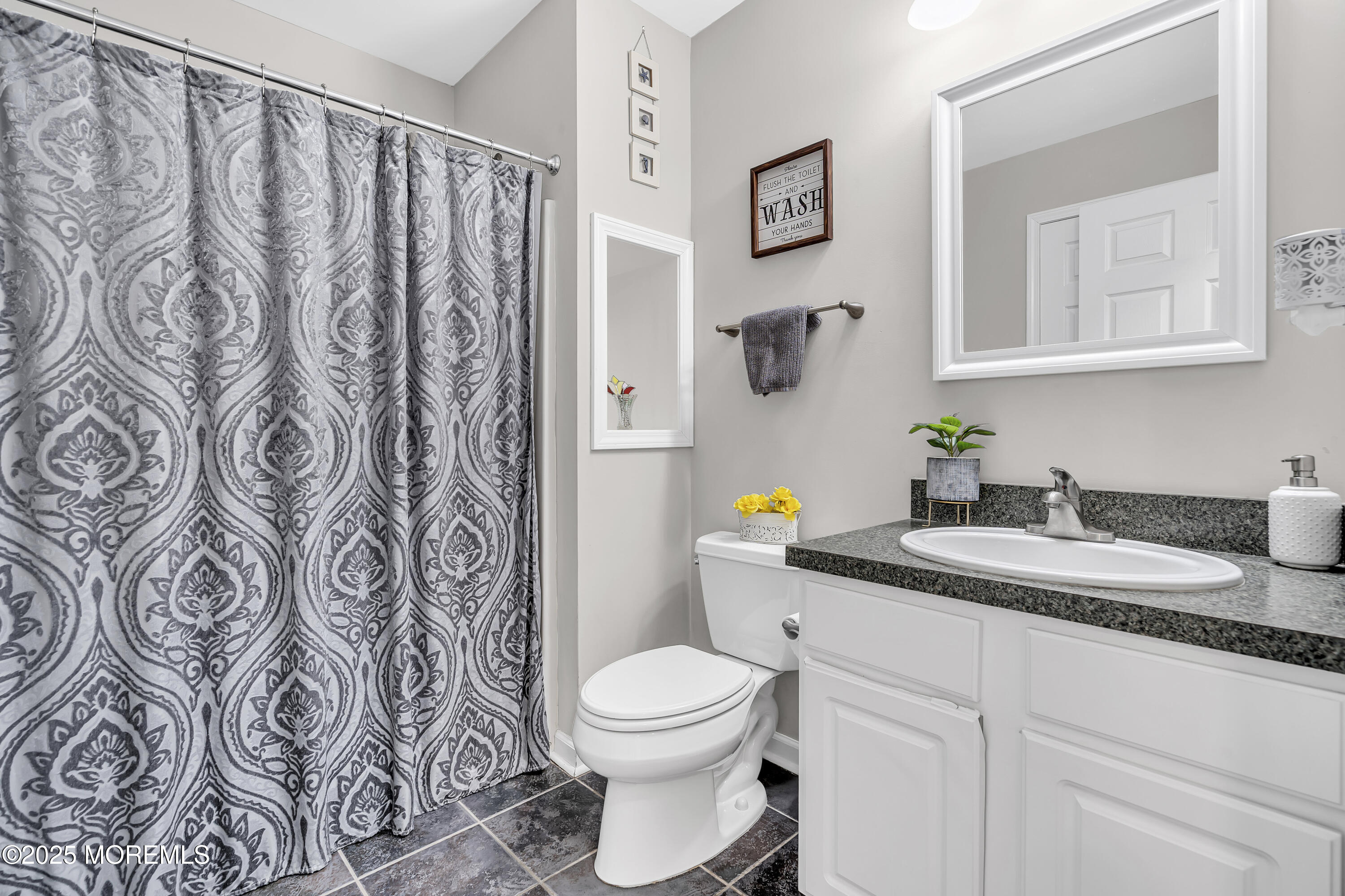 167 Captain Road Manahawkin, NJ 08050 - Photo 33 of 86 a bathroom with a granite countertop sink and a toilet