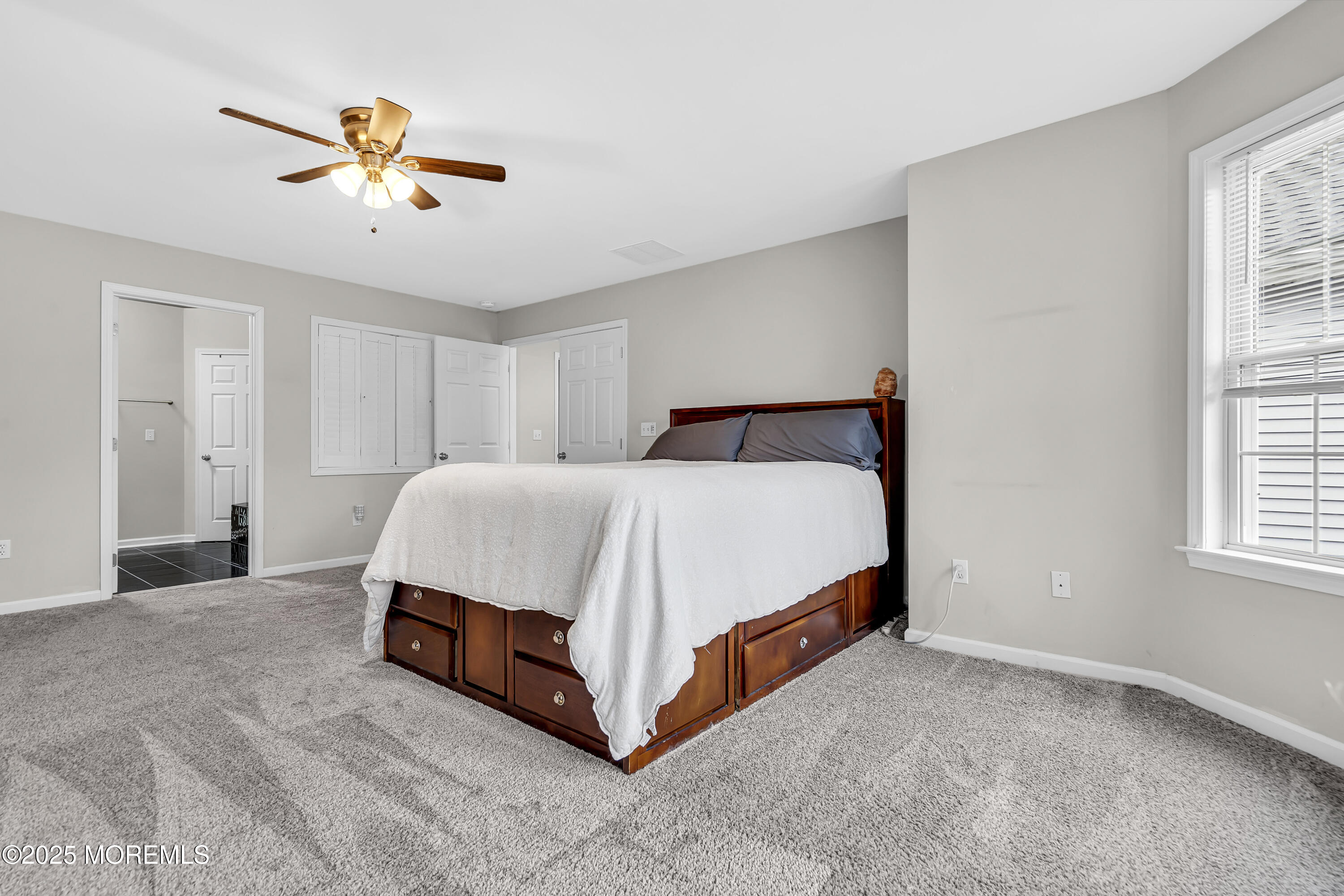 167 Captain Road Manahawkin, NJ 08050 - Photo 44 of 86 a bed sitting in a spacious bedroom next to a window