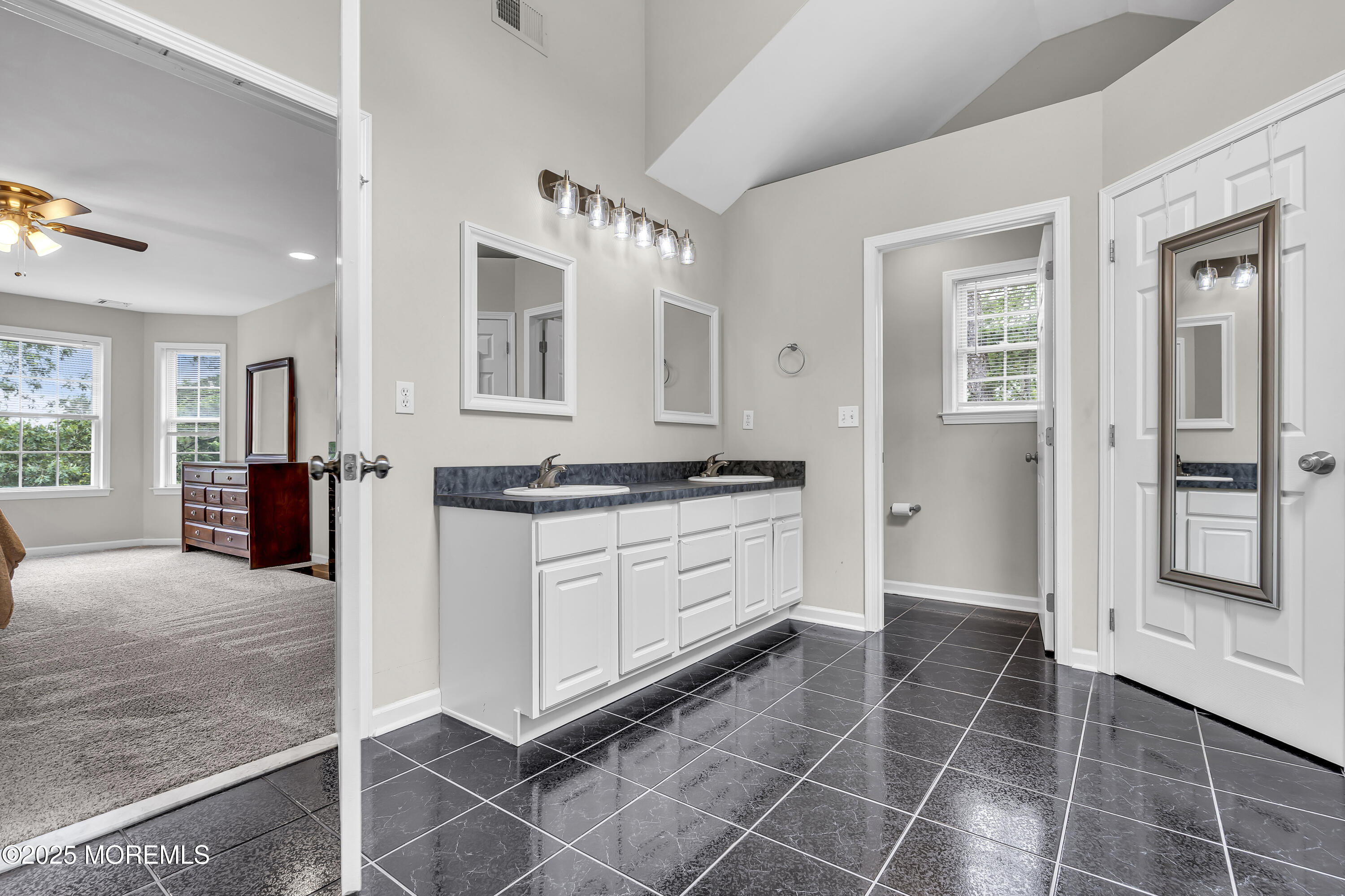 167 Captain Road Manahawkin, NJ 08050 - Photo 48 of 86 a spacious bathroom with a granite countertop sink and a mirror